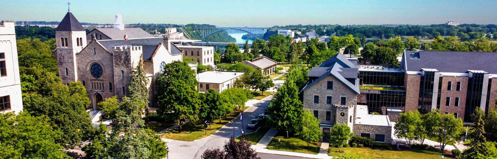 An overhead view of the Niagara University campus in Lewiston, NY, with the Queenston-Lewiston Bridge to Canada in the background.